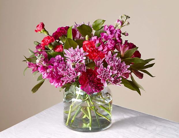 Pink and magenta mixed bouquet in a clear glass vase
