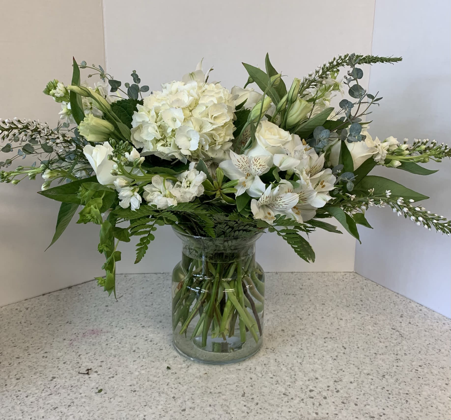 White floral arrangement in a clear glass vase
