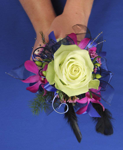 Corsage with a pale green rose and pink accents on a wrist