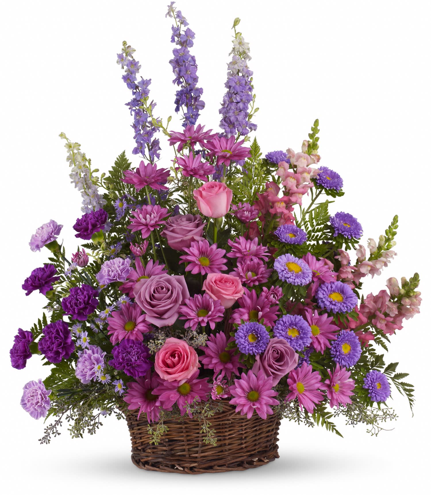 Pink and purple mixed flower arrangement in a wicker basket