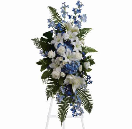 Tall white and blue floral standing spray with fern accents