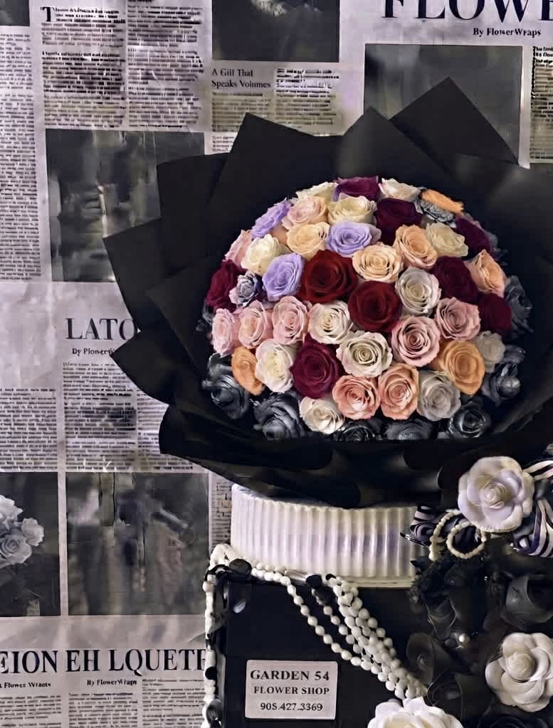 Large bouquet of multicolored roses wrapped in black paper