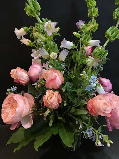 Pink roses and bell-shaped blooms in a mixed bouquet