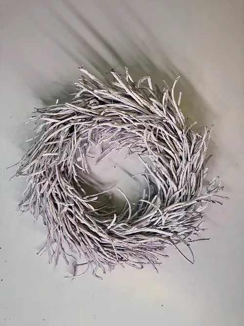 A white twig wreath with a circular opening