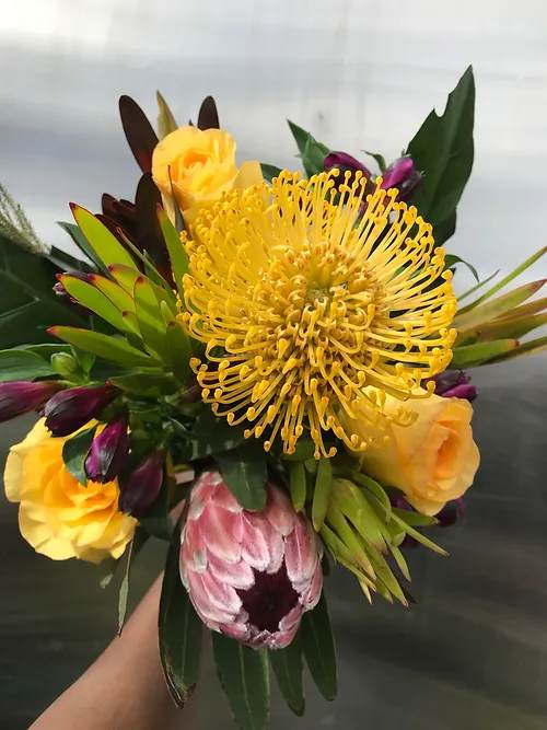 Bouquet with yellow pincushion protea and yellow roses