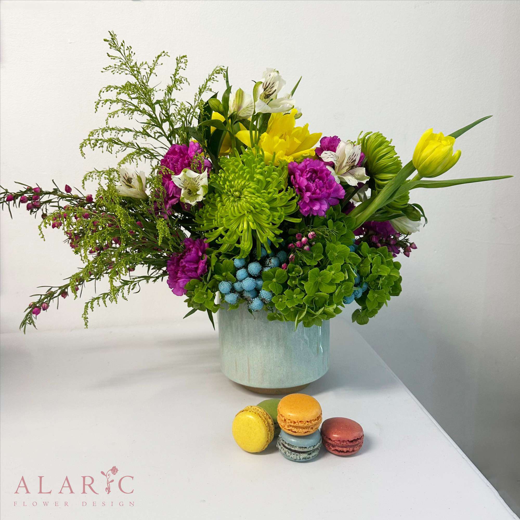 Alara - Here's Alara: a vibrant arrangement, spreading such happy vibes, perfect for any occasion, especially for mother's day!  PS: Macarons in the pictures are not included in the price. Note: Pot shape or color may vary upon availability.