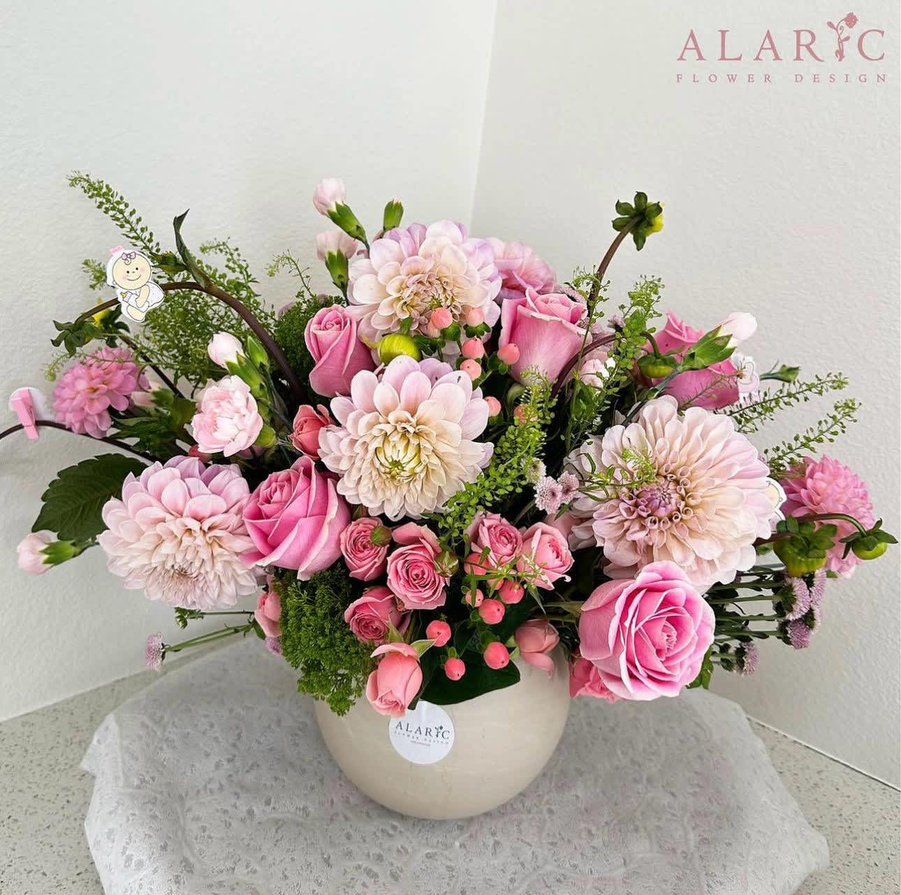 Anita - Anita is a classy gorgeous mix of pink and green spring blooms. This arrangement can be gifted for different occasions or simply used as a centerpiece during events, such as baby showers, bridal showers, welcome baby, birthdays and more!