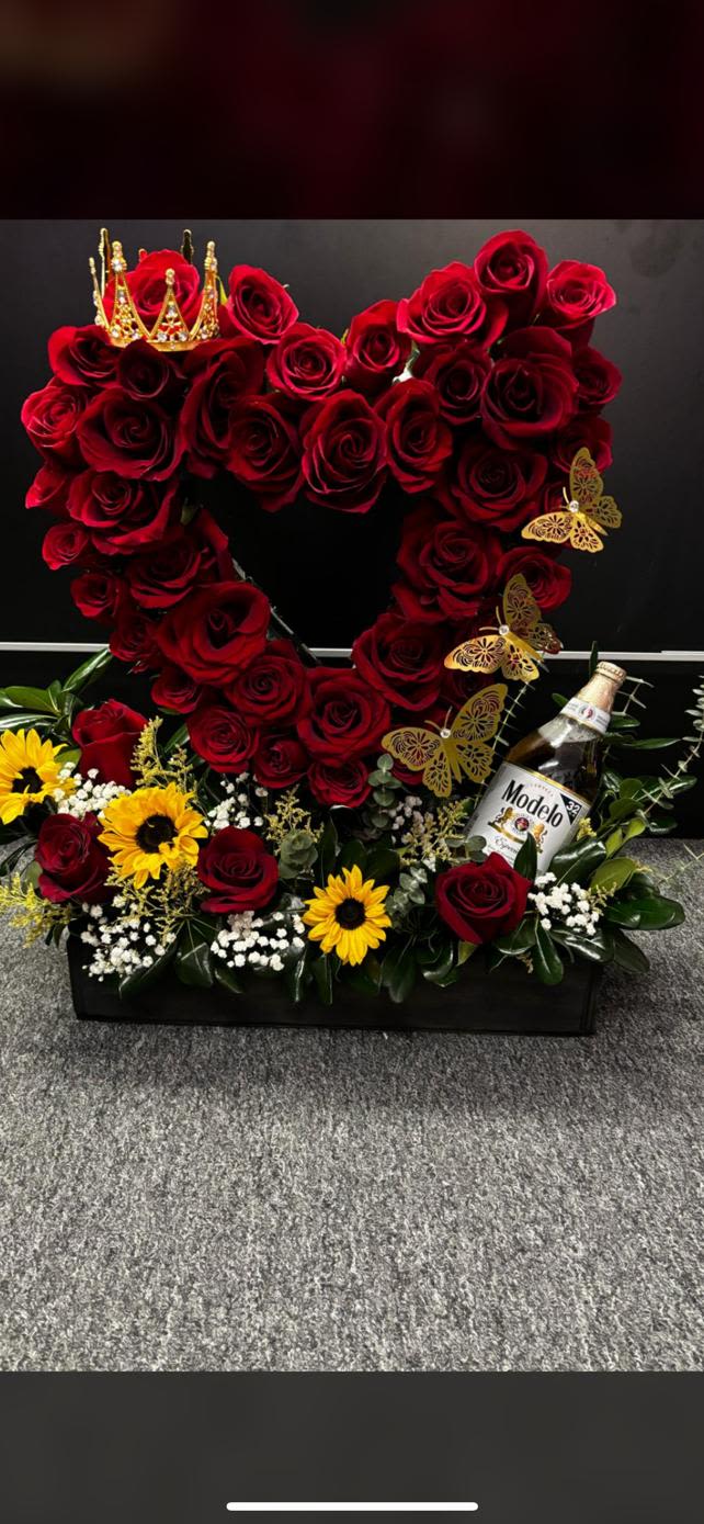 Heart-shaped red rose arrangement with sunflowers and a bottle of Modelo