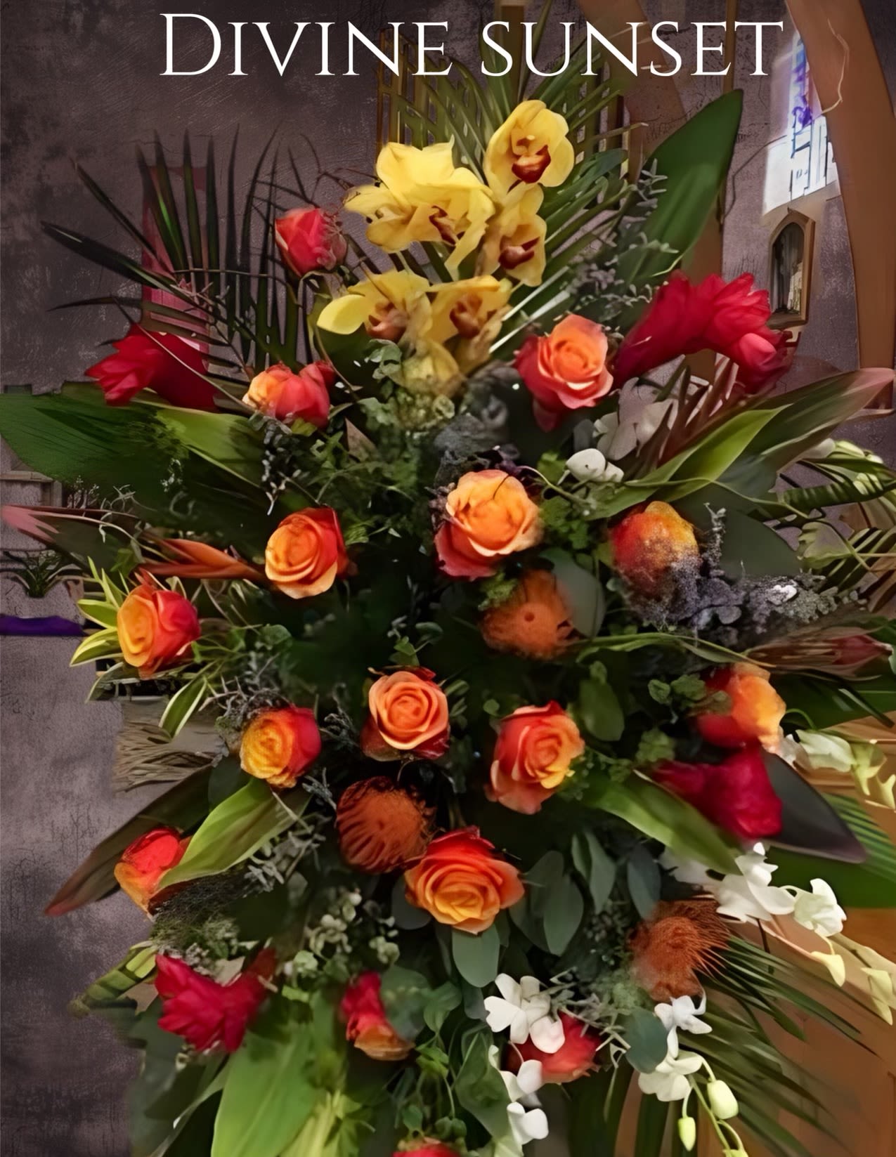 Tall floral spray with orange roses, yellow orchids, and red blooms