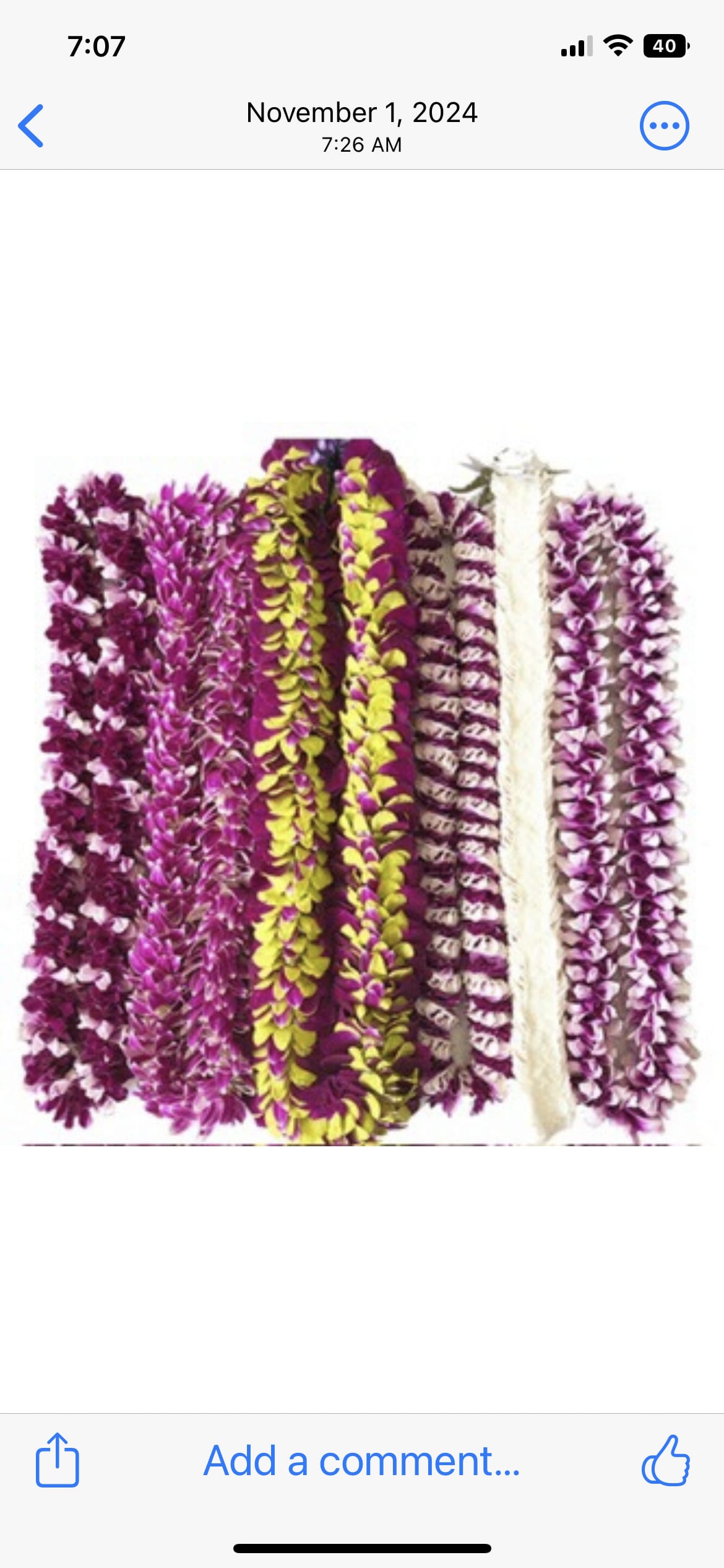 Several purple and yellow flower leis arranged side by side.