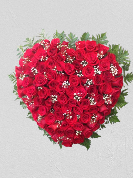 Heart-shaped bouquet of red roses with baby's breath
