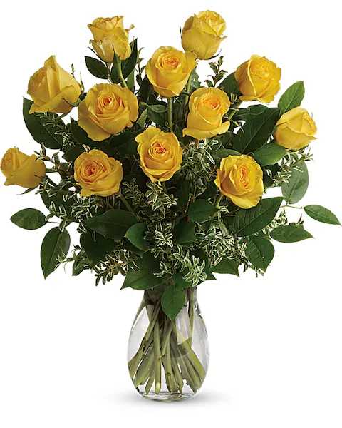 Yellow roses arranged in a clear glass vase