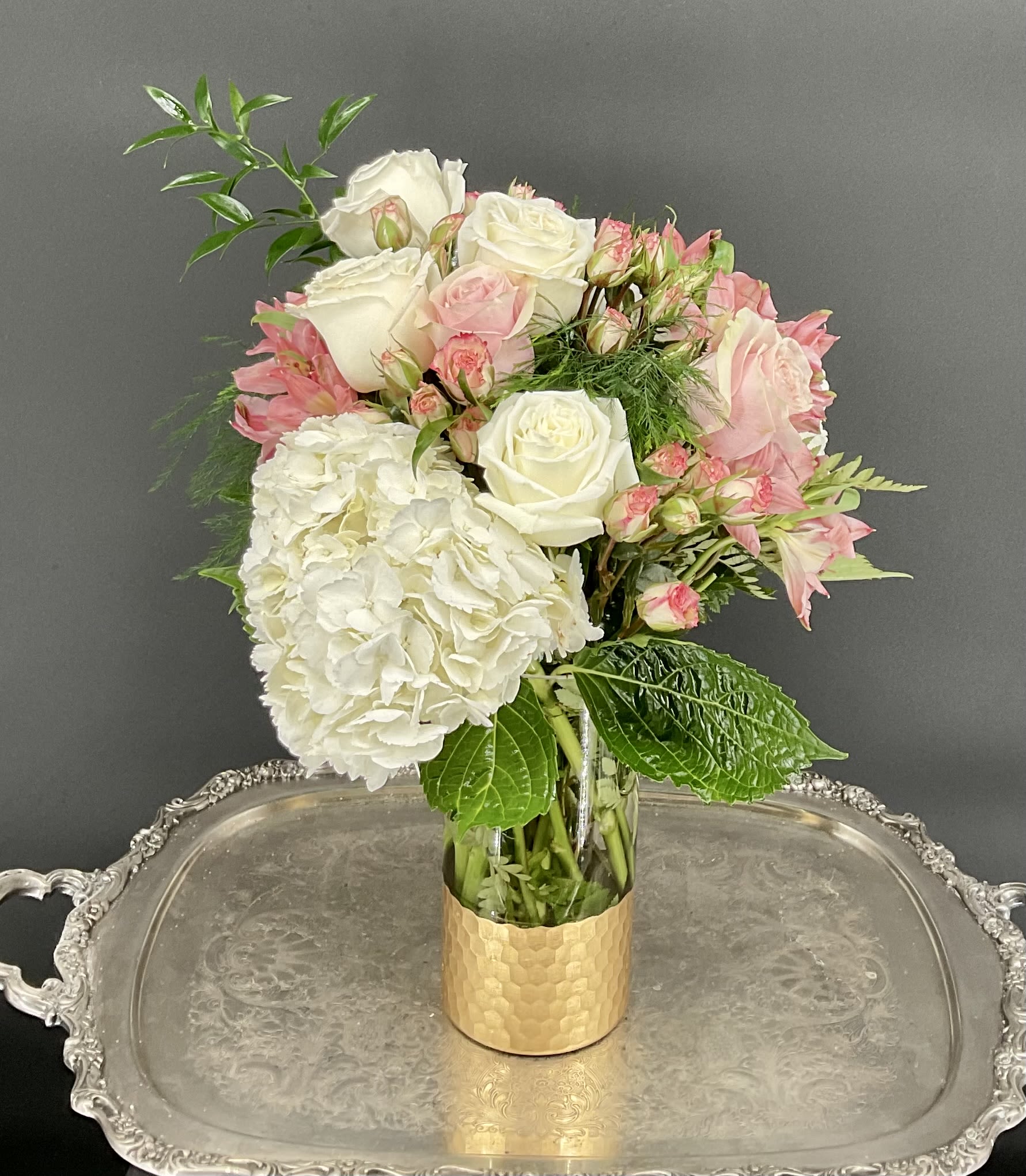 Pink and white bouquet in a gold vase