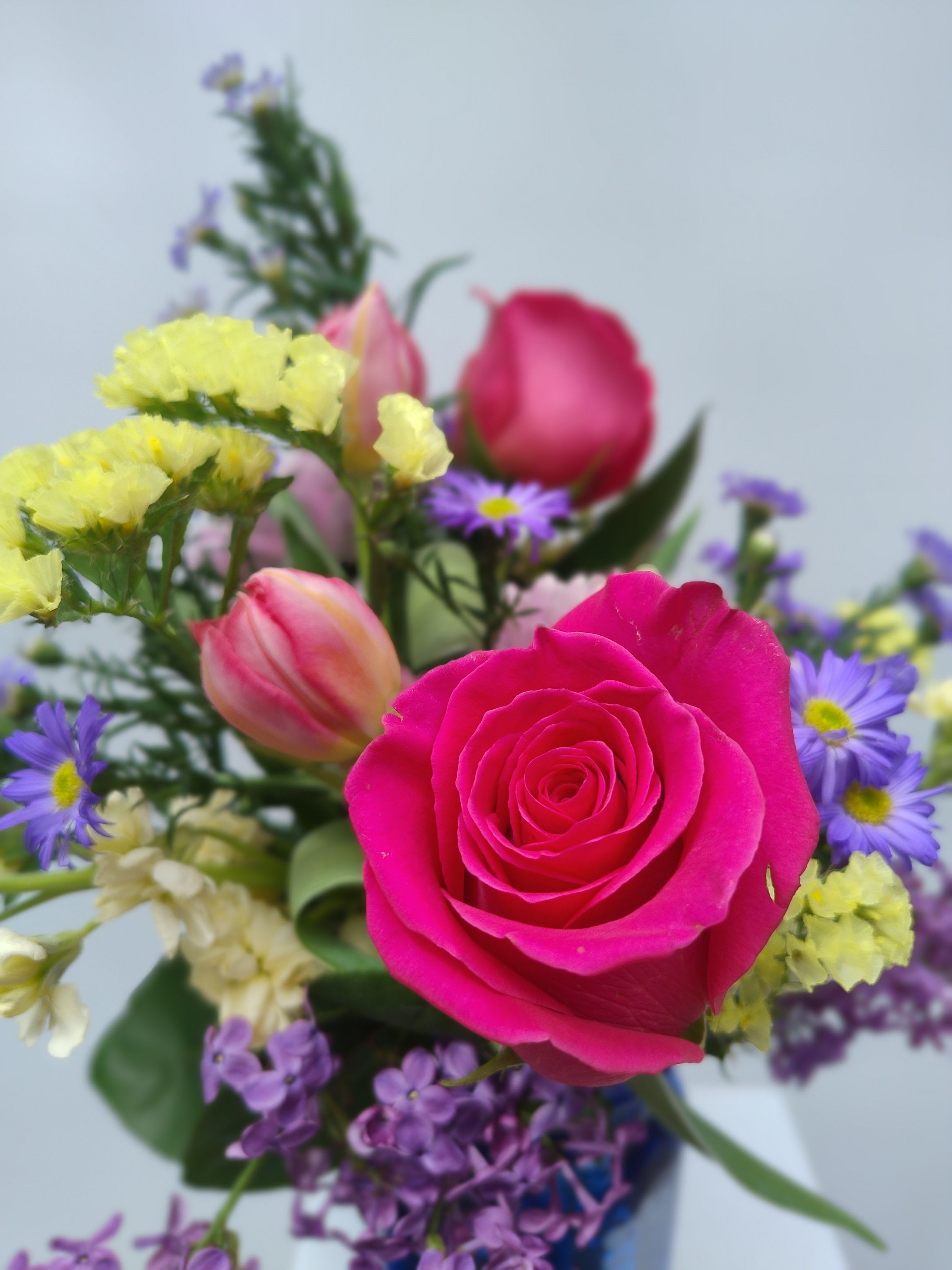 Pink rose bouquet with purple and yellow filler flowers