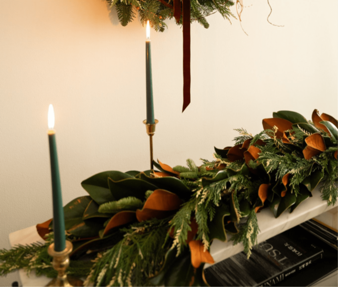 Long evergreen garland with candles on a mantel