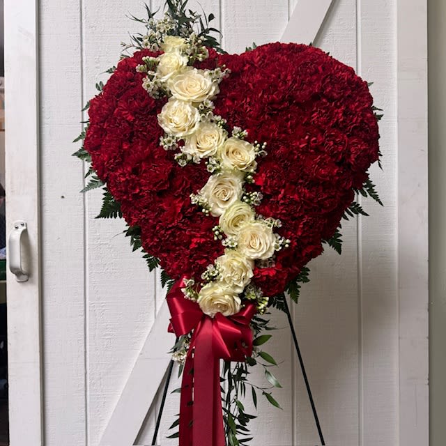 Heart-shaped red floral standing spray with white roses and a red ribbon