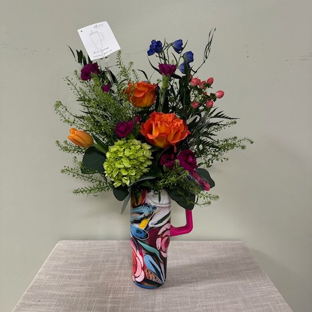 Colorful bouquet in a patterned mug-style vase