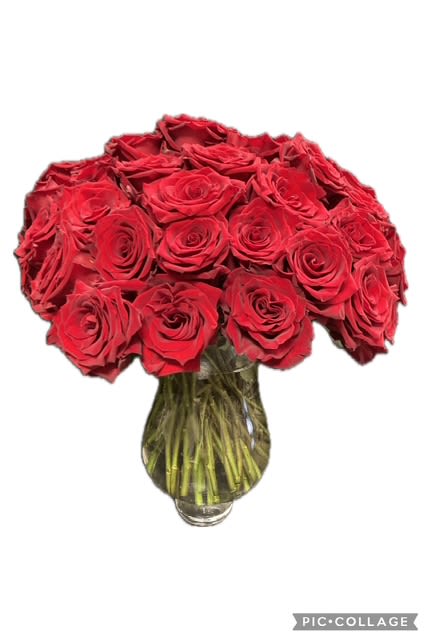 Red roses arranged in a clear glass vase