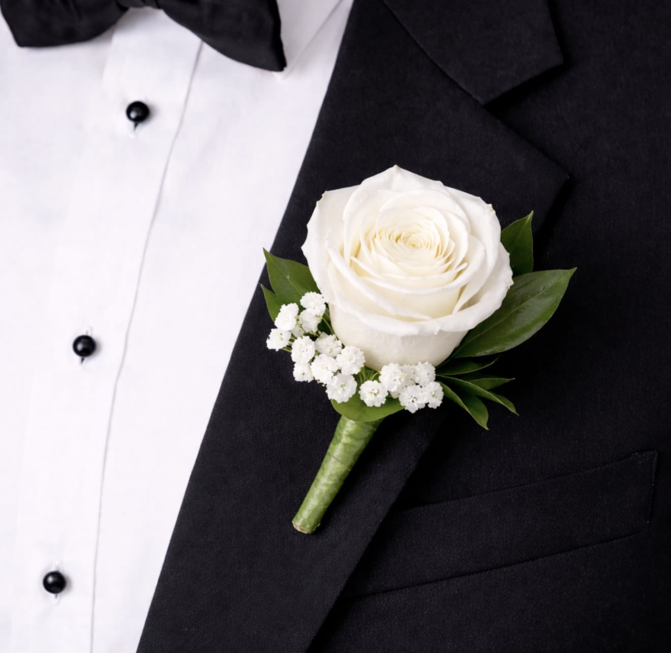 Boutonniere with White Rose - This white rose boutonniere is a timeless lapel accessory featuring a single, elegant white rose accented with delicate greenery. 