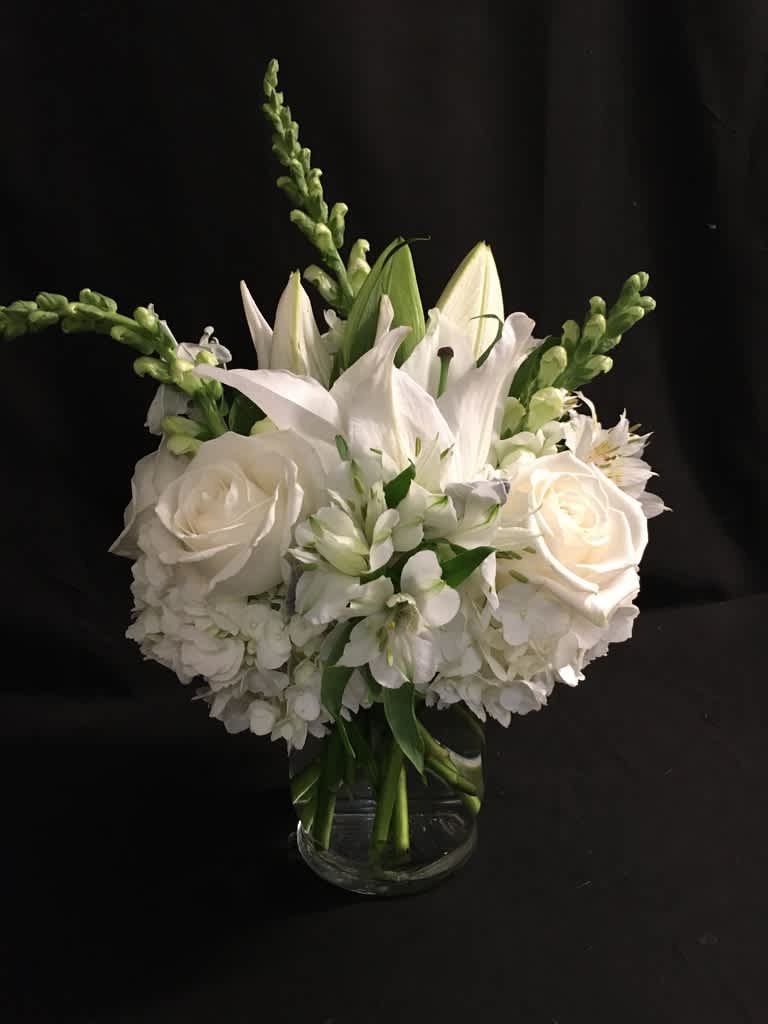 White floral bouquet in a clear glass vase