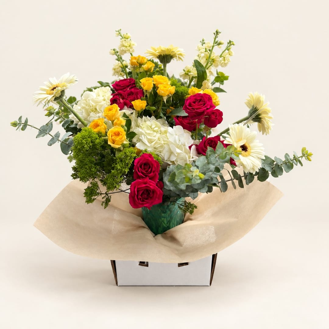 Bouquet of red and yellow roses with white daisies in a vase