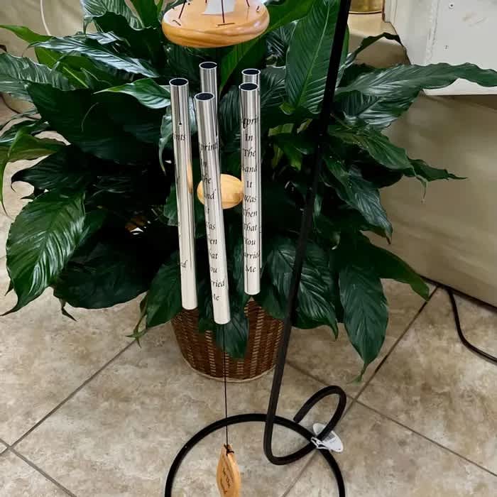 Potted green plant with tall silver memorial tubes