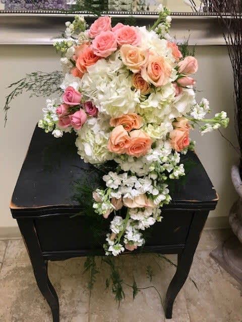 Cascade bouquet of pink and peach roses with white hydrangeas