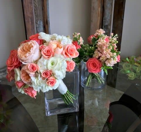 Bouquets of pink and white roses in clear glass vases