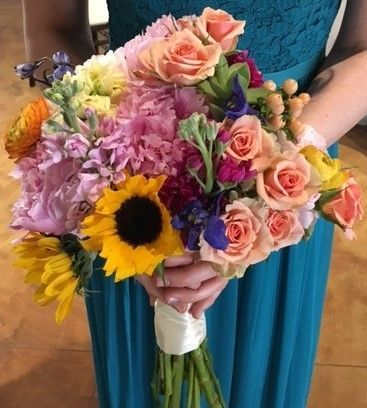 Colorful hand-tied bouquet with roses and a sunflower
