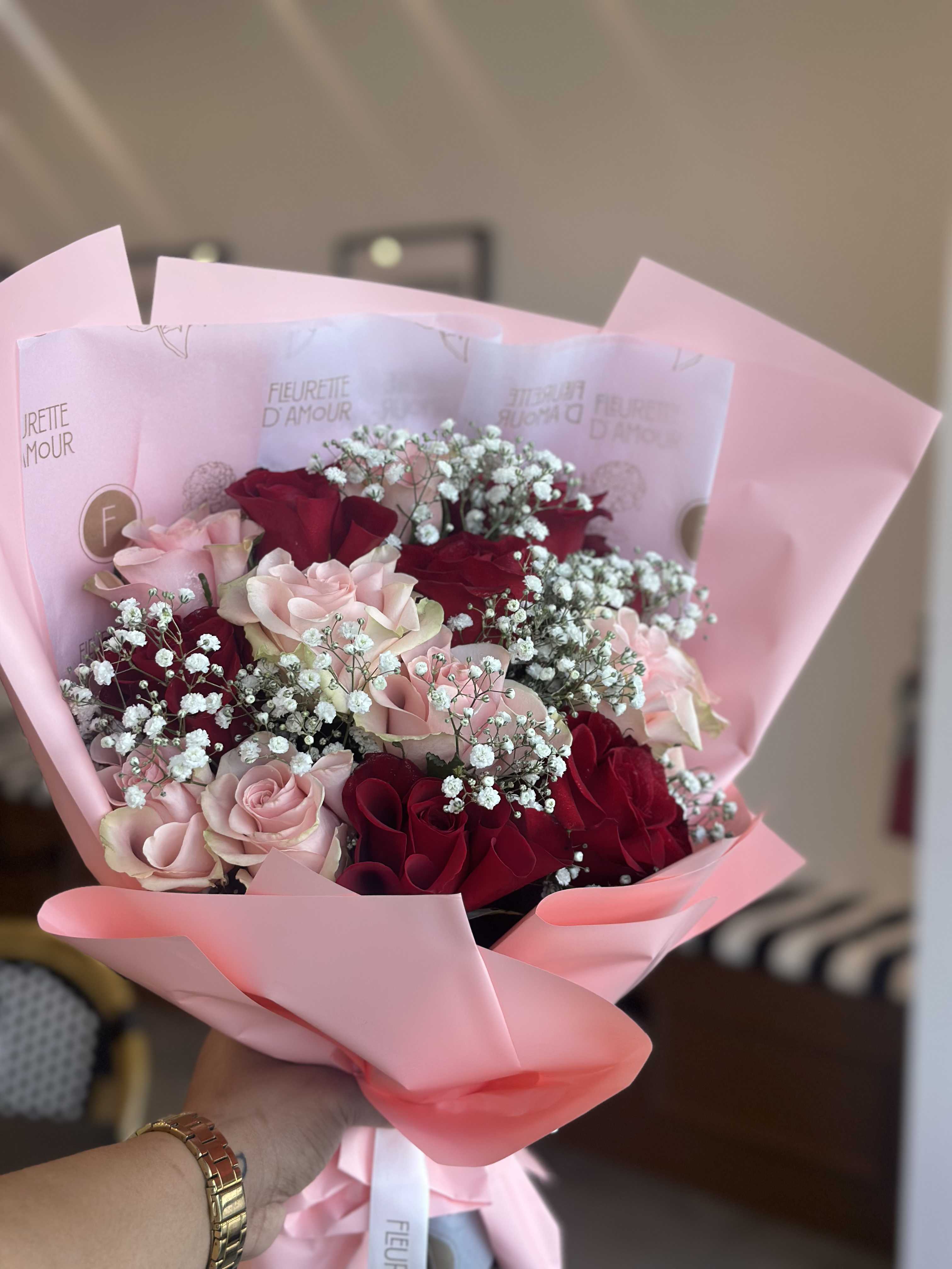 Pink and red rose bouquet wrapped in pastel pink paper