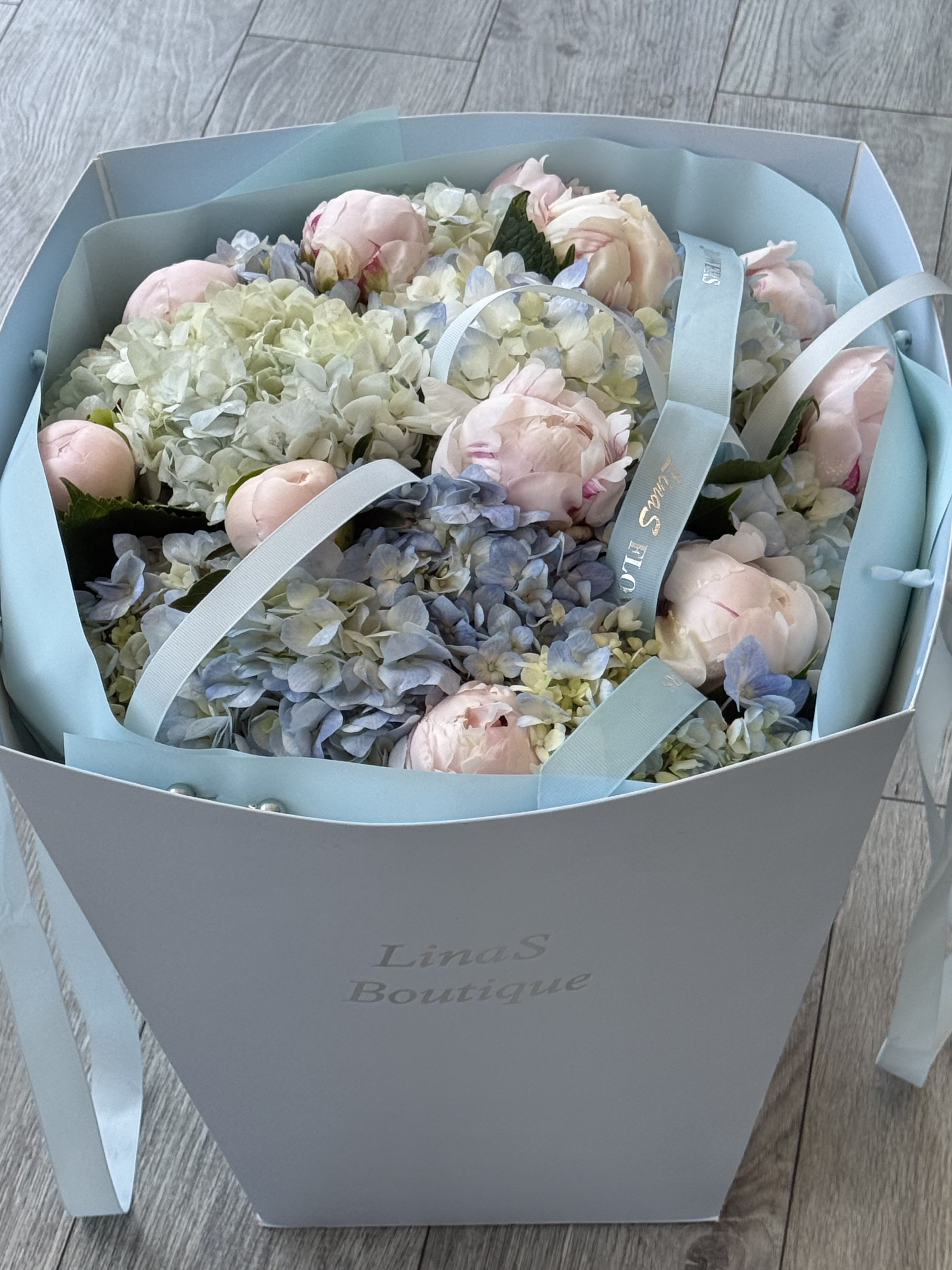 Romance  - A dreamy blend of soft pink peonies and delicate blue hydrangeas, designed with elegance and charm to create a fresh, romantic statement bouquet full of beauty and grace.