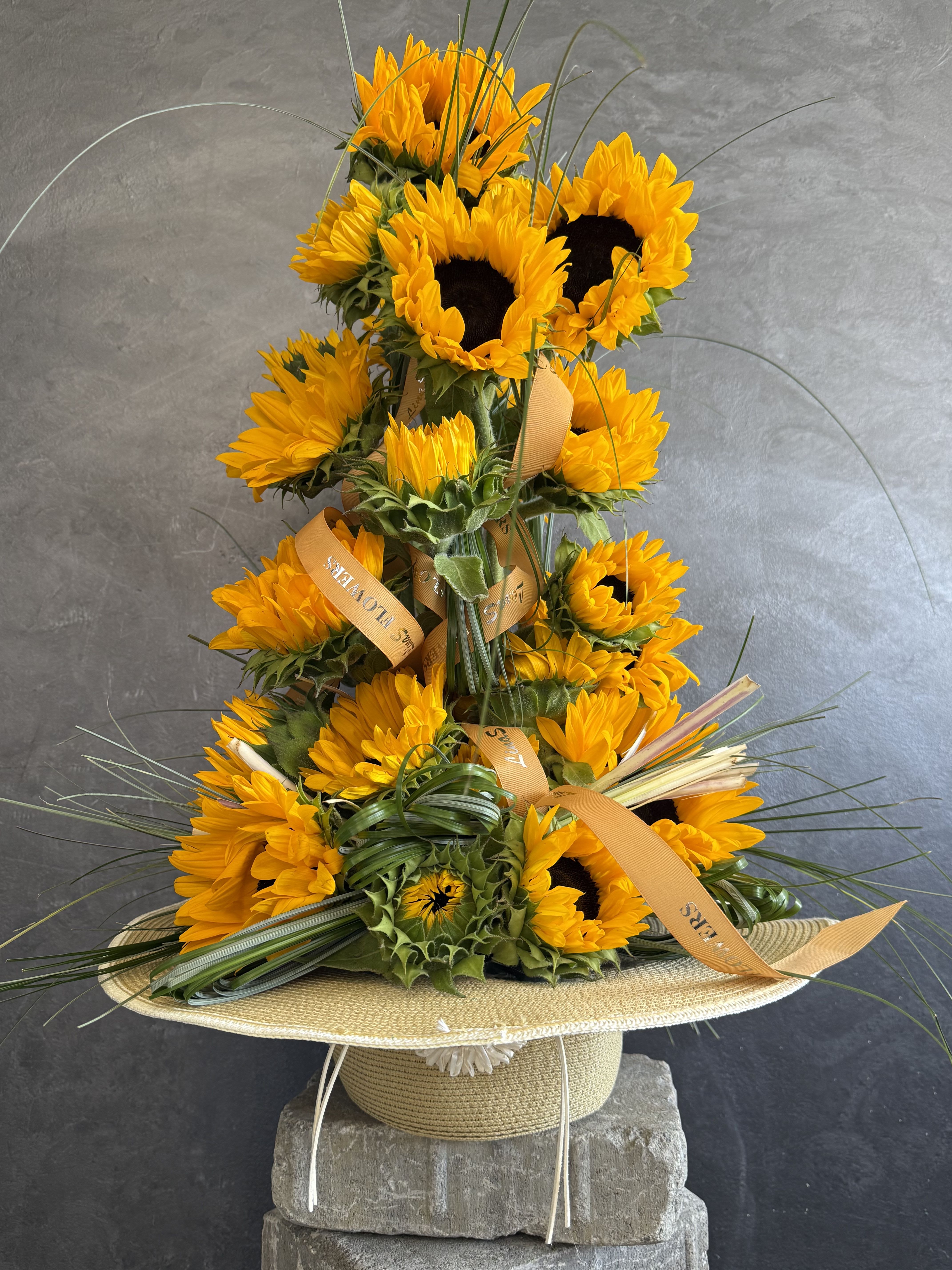     Sunshine Hat ️ - A breathtaking designer arrangement featuring vibrant sunflowers artfully styled into an elegant sun hat. Radiating warmth, joy, and summer charm, this one-of-a-kind creation is perfect for birthdays, celebrations, housewarmings, or anyone who loves bold floral artistry. ️