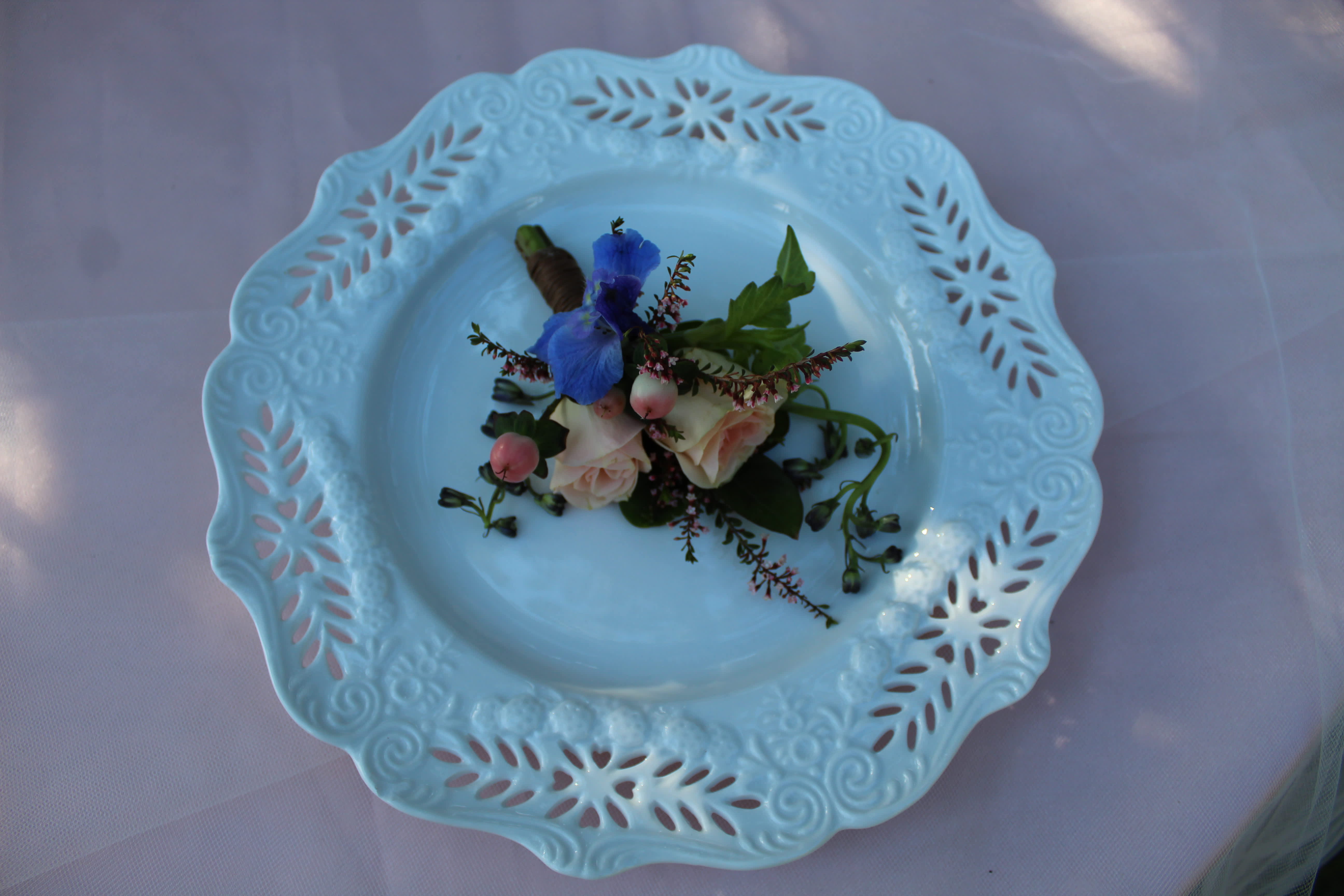 Small floral corsage on a decorative blue plate
