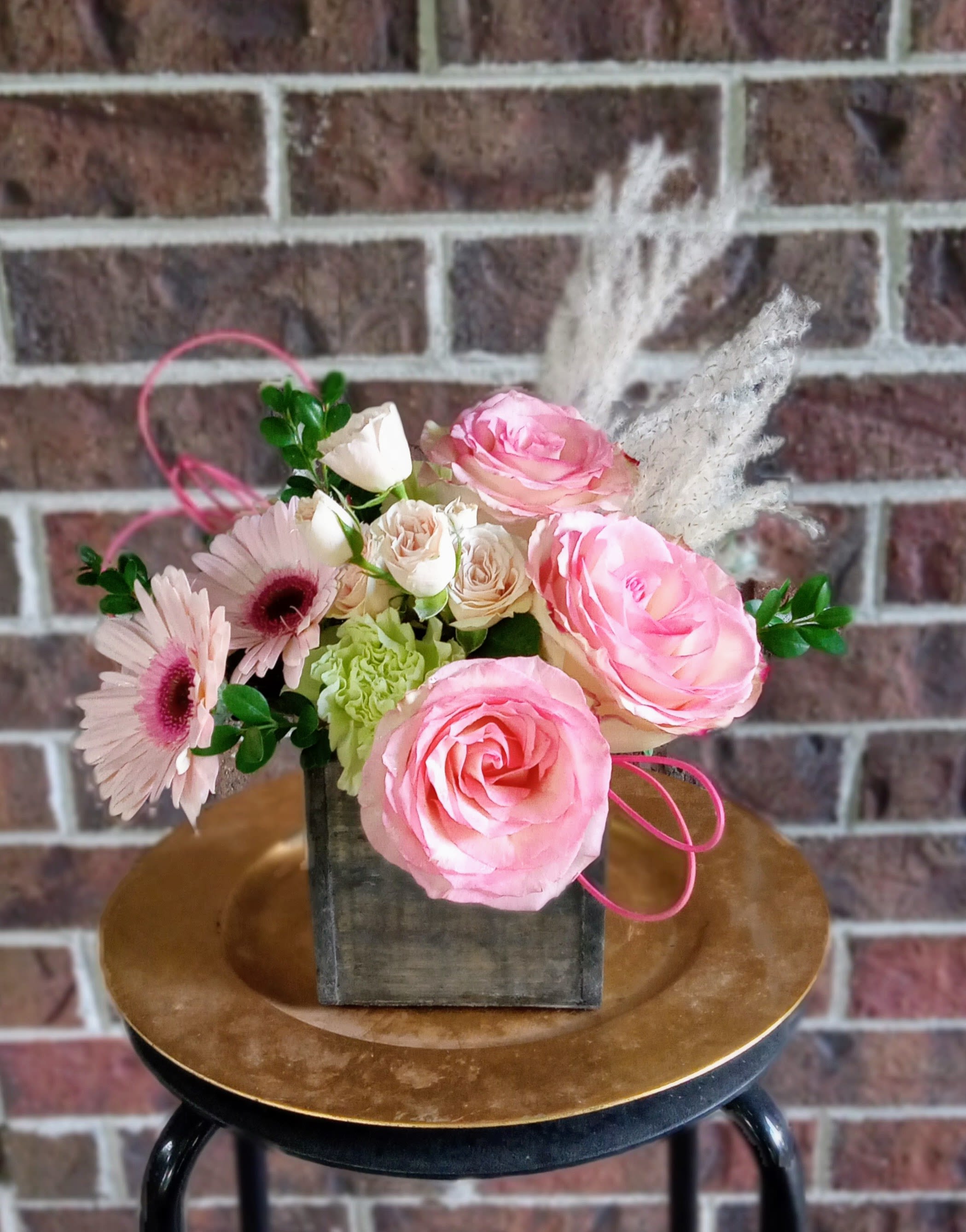 Boho Breeze by BloomNation™ - A boho arrangement featuring an eclectic mix of flowers and textures.  This modern wooden cube contains pink gerbera daisies, green roses, white spray roses, solidago and dried grasses.  This arrangement is a very trendy gift and good for lots of different occasions.    Approximate Dimensions: 9"D x 13"H