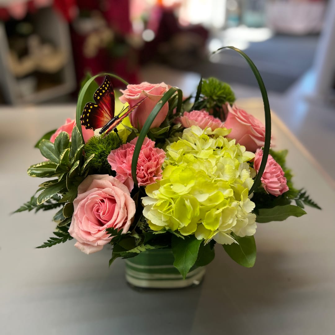 Pink roses and carnations with lime hydrangea in a glass vase