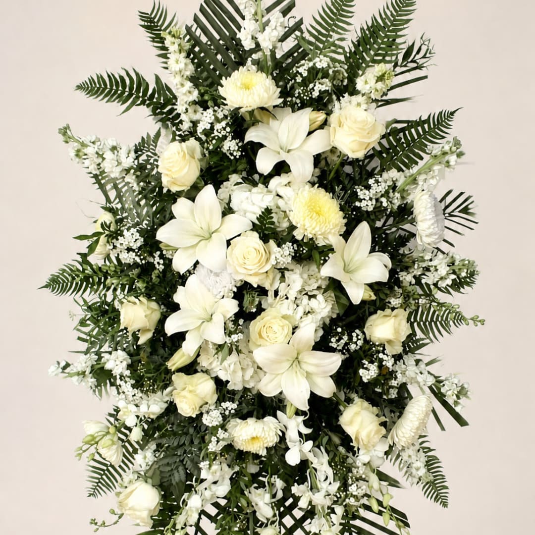 White floral standing spray with lilies and roses