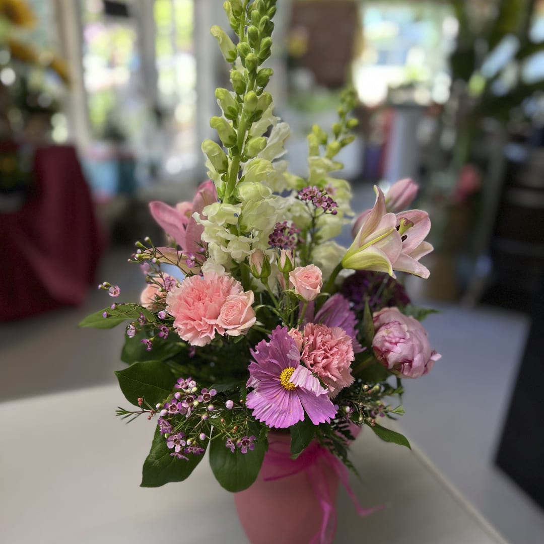 Pink and white mixed flower arrangement in a pink vase