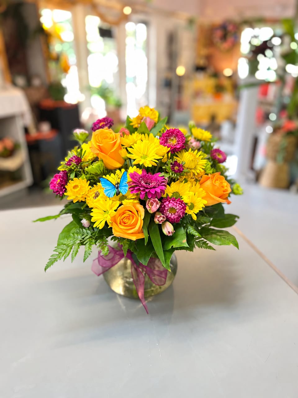 Bright mixed bouquet of yellow and orange flowers in a glass vase