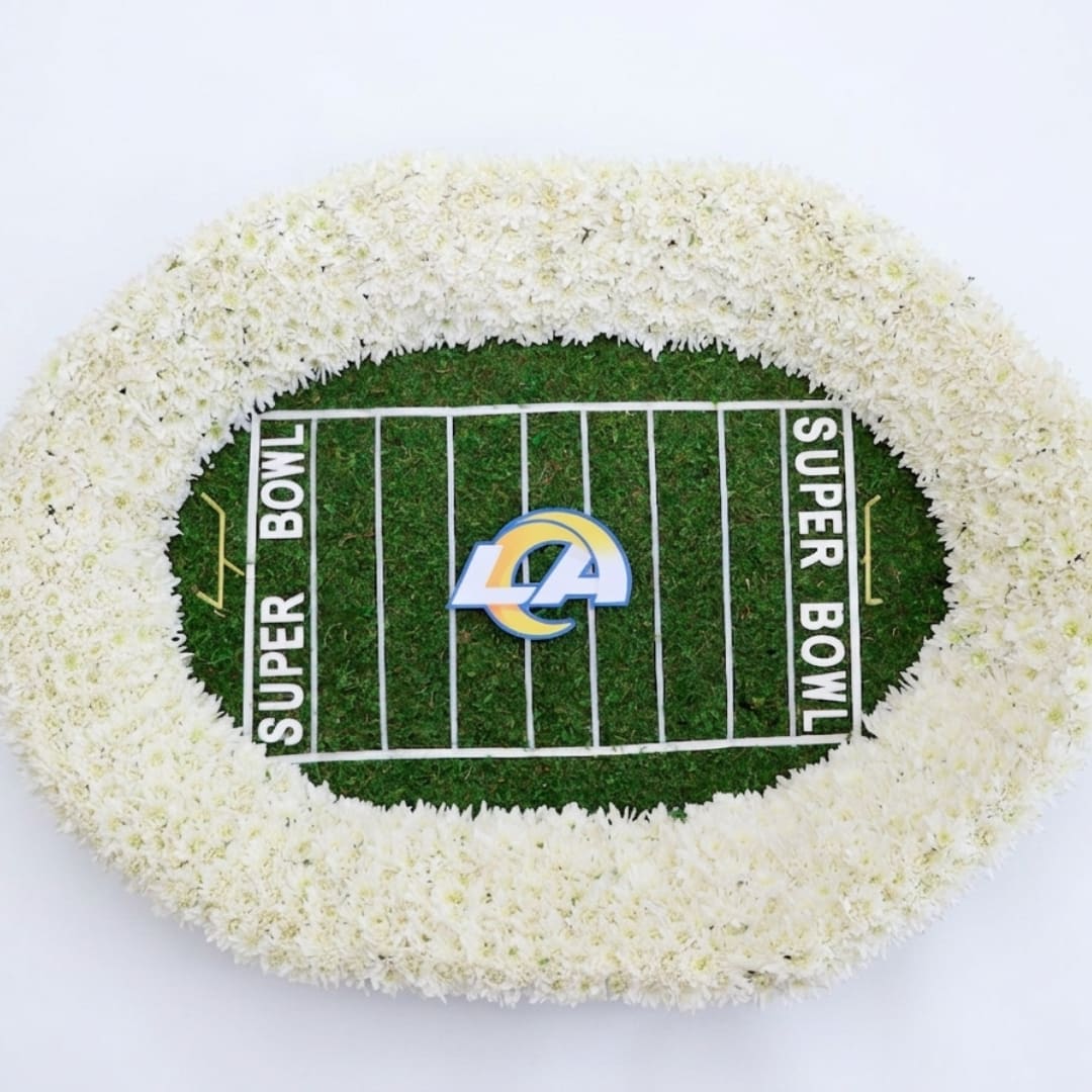 White floral football field arrangement with a Super Bowl logo in the center