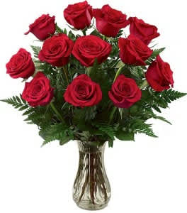 Red roses arranged in a clear glass vase