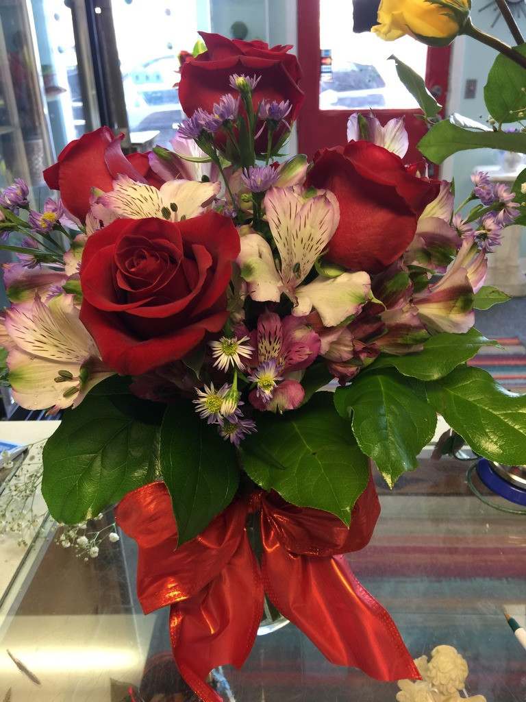 Bouquet of red roses and pink alstroemeria with a red ribbon