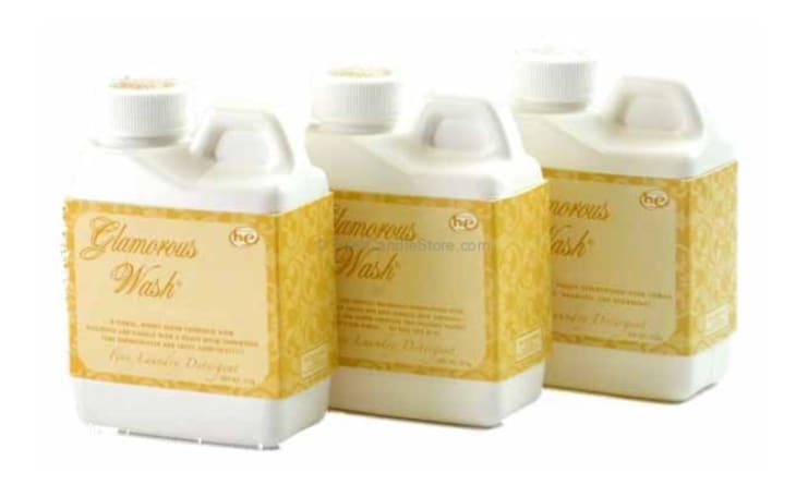 Three white plastic bottles with gold labels