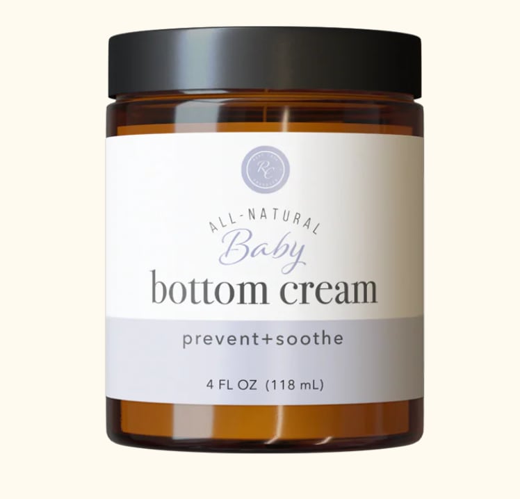 Amber jar of baby bottom cream with a black lid