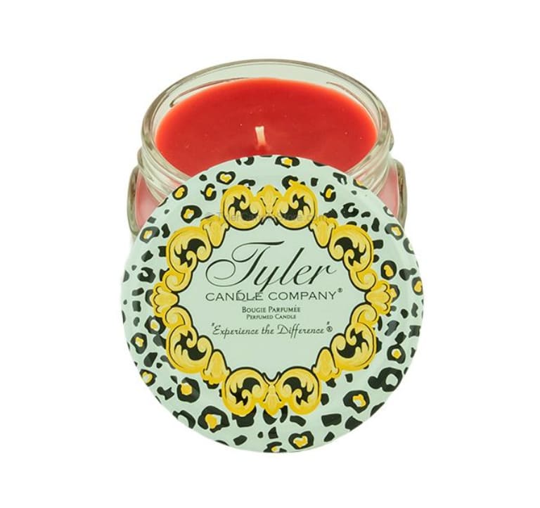 Red candle in a glass jar with a patterned lid