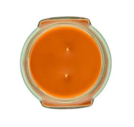Orange candle in a clear glass container