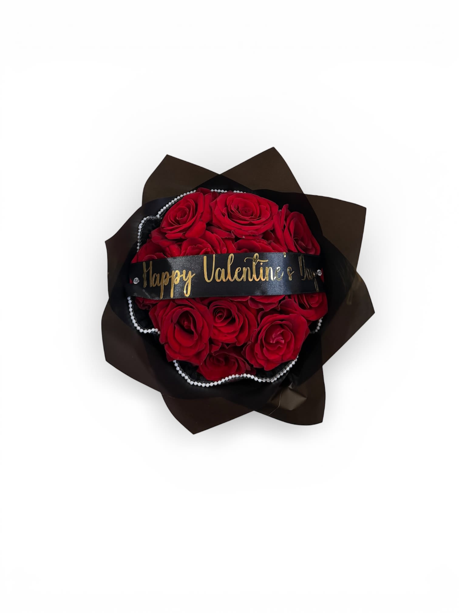 Round bouquet of red roses wrapped in black paper with a Happy Valentine’s Day ribbon and pearl accents.