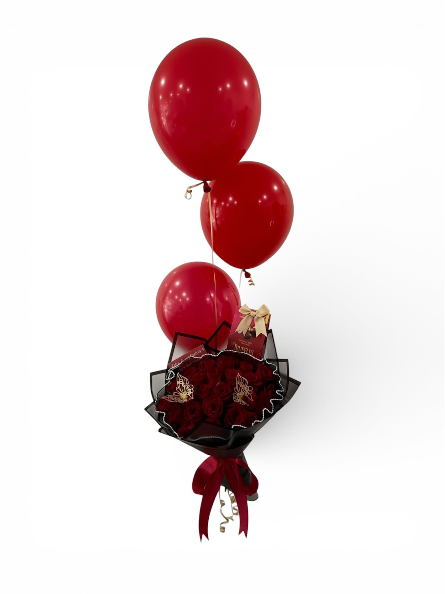 Red rose bouquet with a chocolate box and three red balloons tied above.