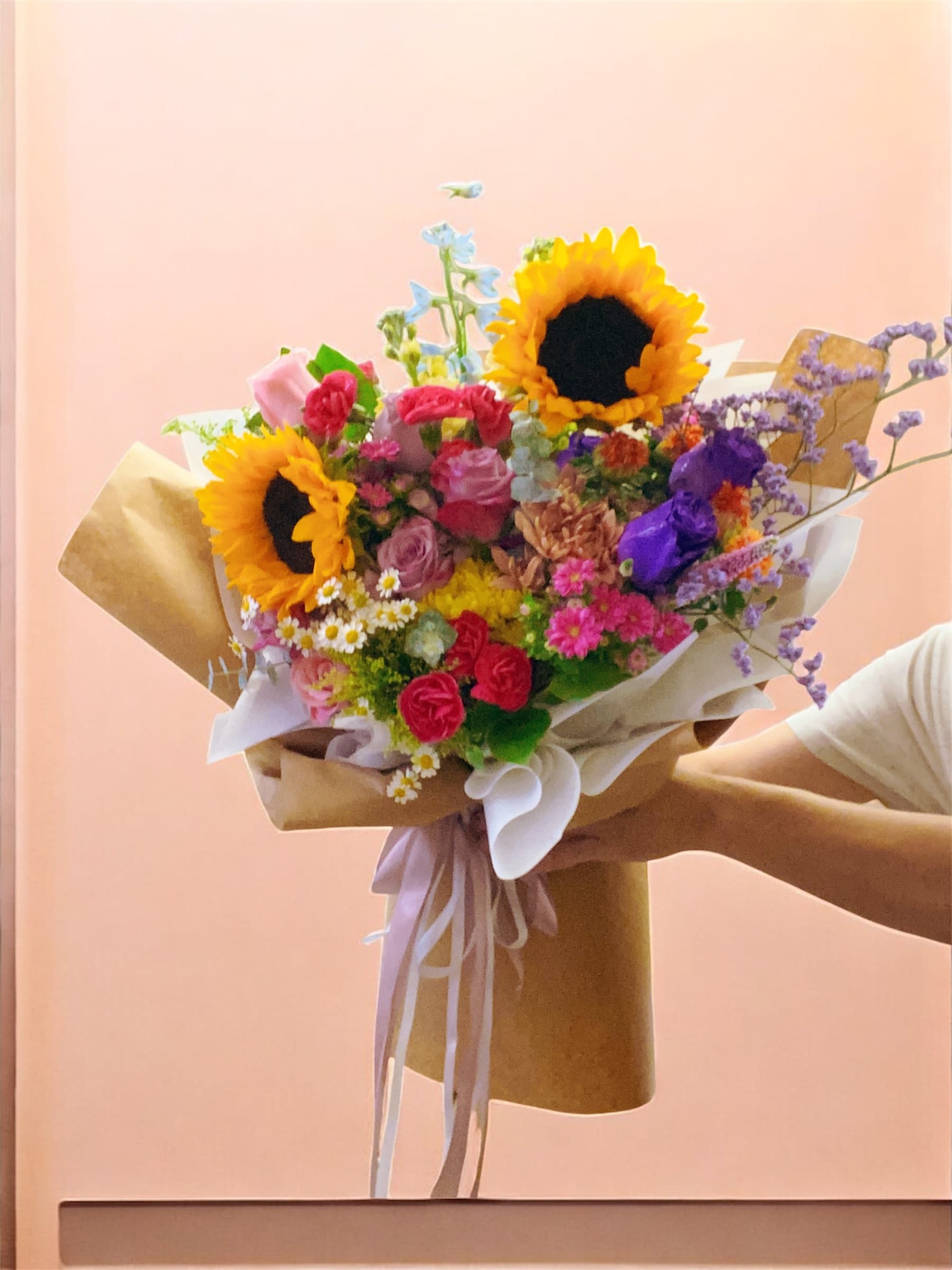 Brown paper wrapped colorful flowers bouquet  - Brown paper wrapped colorful flowers bouquet 