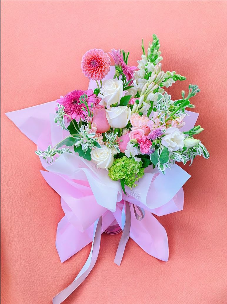 Pink and white mixed bouquet wrapped in pastel paper