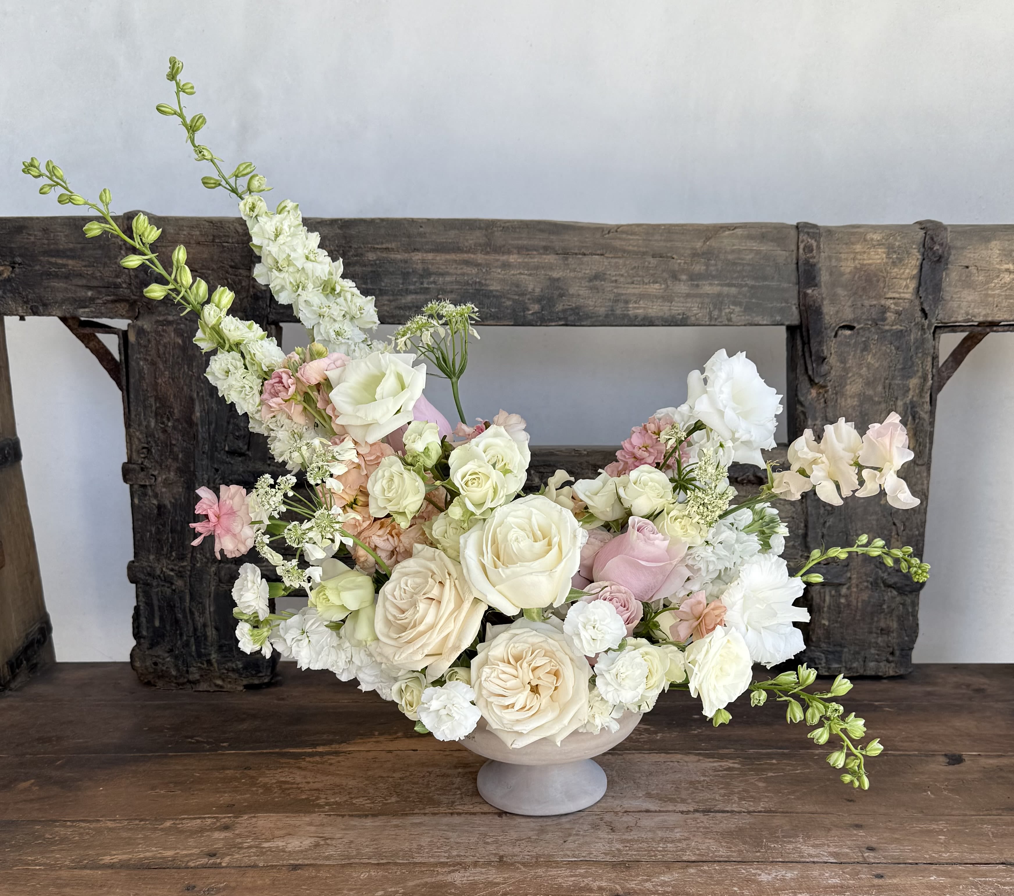 Blushing Petals - Soft, subtle, and full of charm. Designed in a statement compote, this arrangement is ideal for marking life’s special moments—or simply making someone smile.